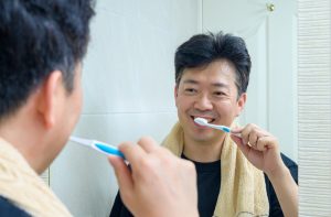 man brushing teeth